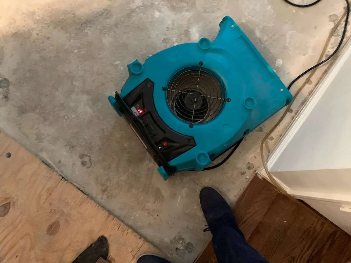 Air mover drying subfloor during Leak Detection & Repair in West Manheim